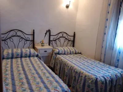 Cama o camas de una habitación en CORTIJO Rural MOLINO EL TARAHAL con piscina y zonas compartidas