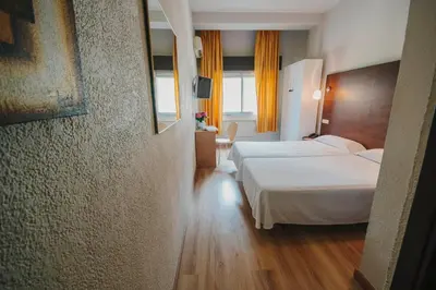 Cama o camas de una habitación en Hotel Embajador