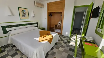 Cama o camas de una habitación en Hotel El Puntazo I