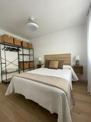 Cama o camas de una habitación en Apartamentos La Hormiga Deluxe
